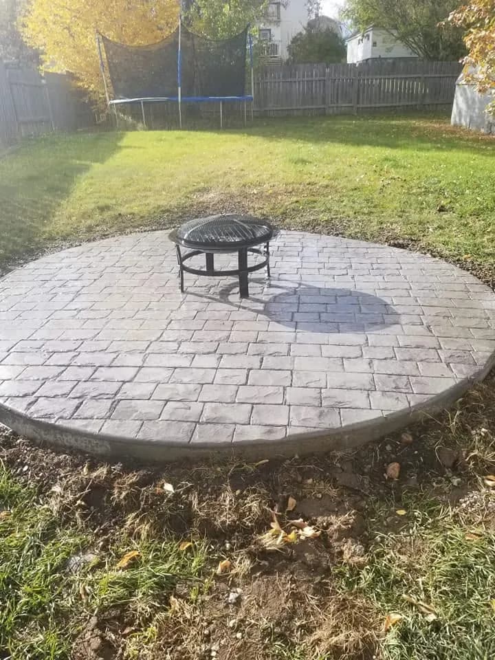 Stamped concrete patio with a fire pit in Prince Albert SK