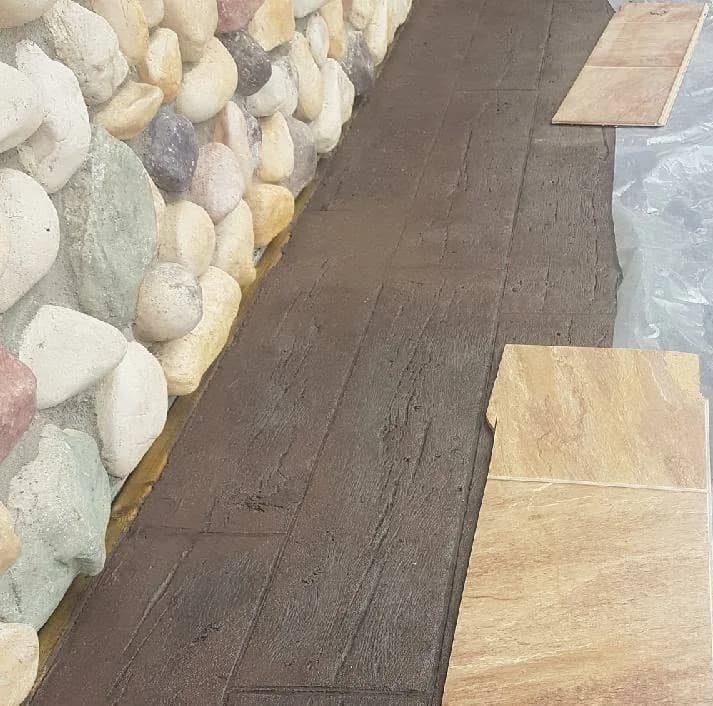 Exposed aggregate concrete walkway with a rock border in Prince Albert SK